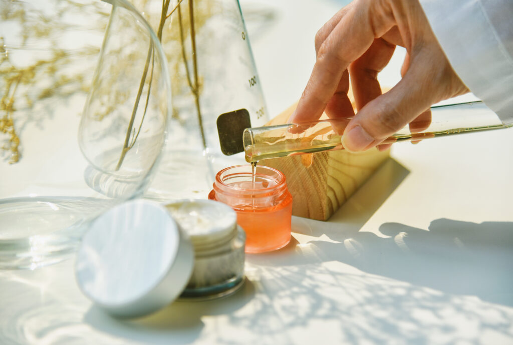 hand with cosmetic ingredients in a lab