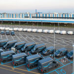 Top view of Amazon Prime electric delivery vans, parked at ..the logistics hub of Amazon